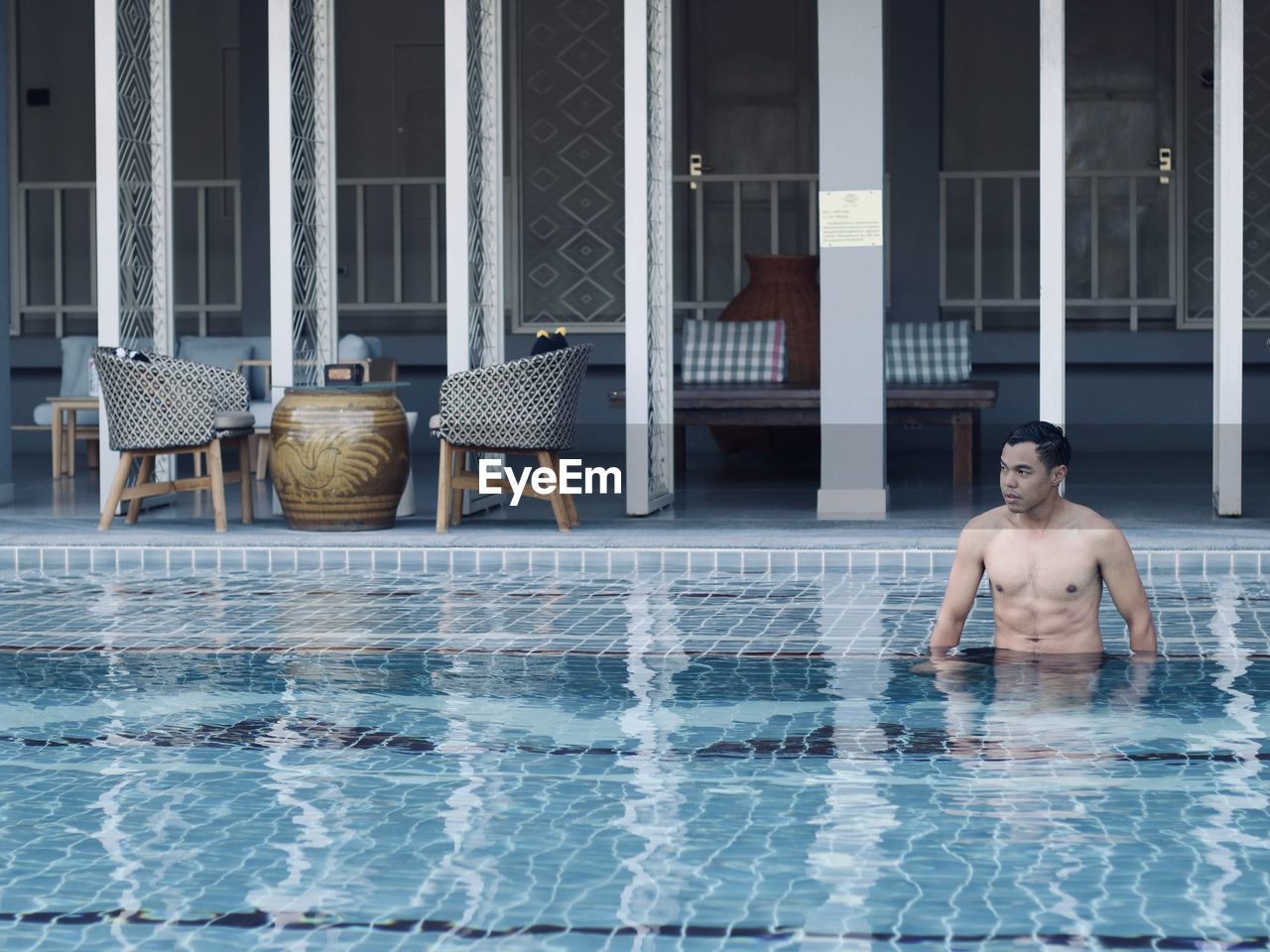 Full length of shirtless man in swimming pool