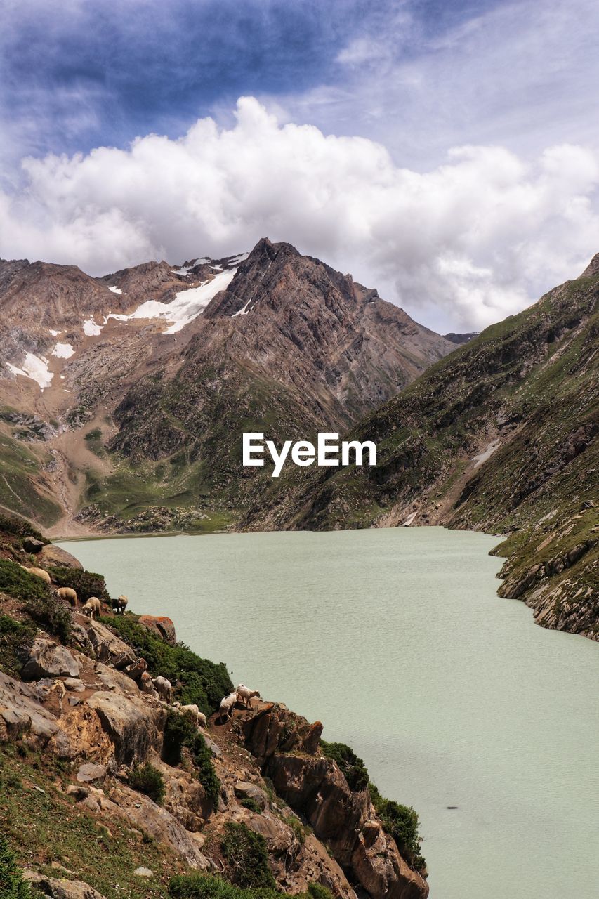 Scenic view of lake and mountains against sky