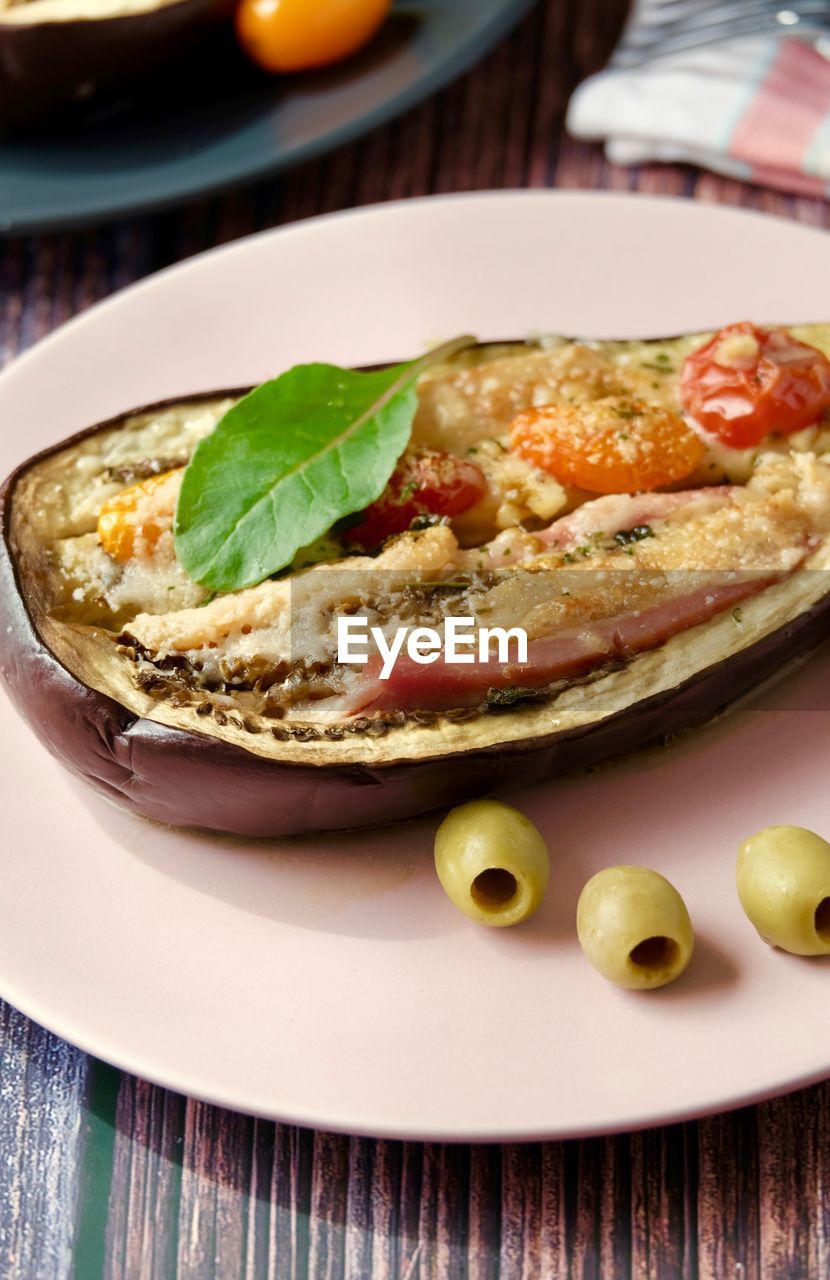 Eggplant baked in the oven with prosciutto cotto and parmesan cheese and olive