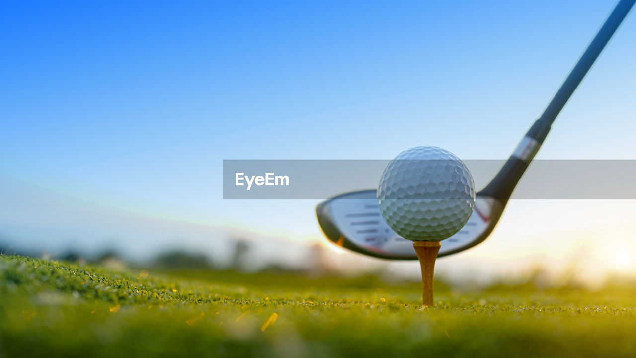 golf ball on grass against clear sky