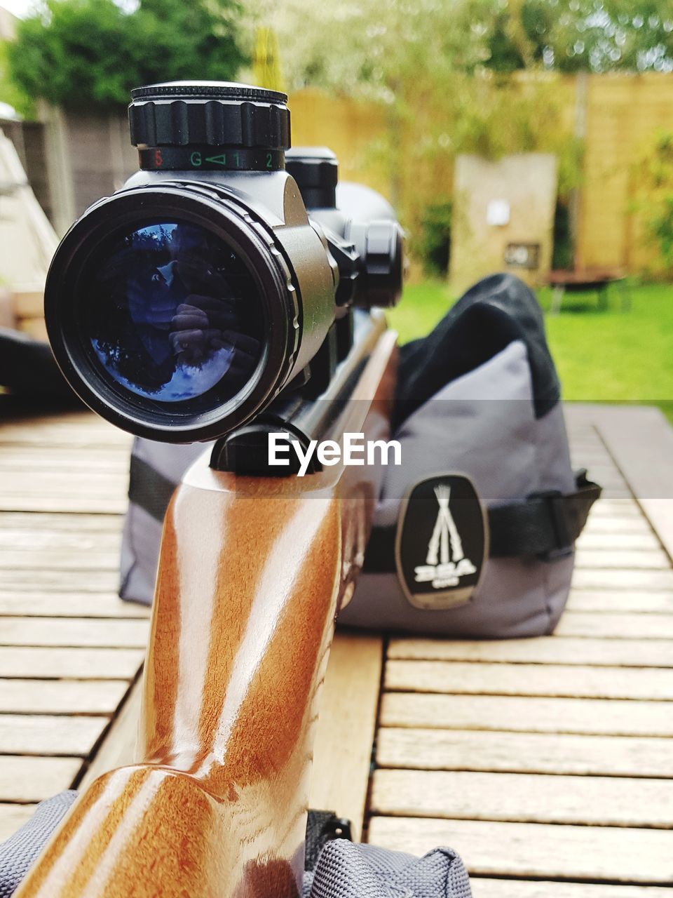 Close-up of sniper rifle on table