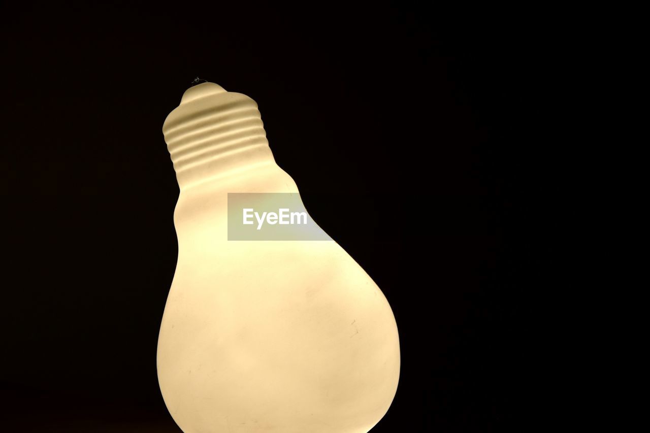 Close-up of a light bulb against black background