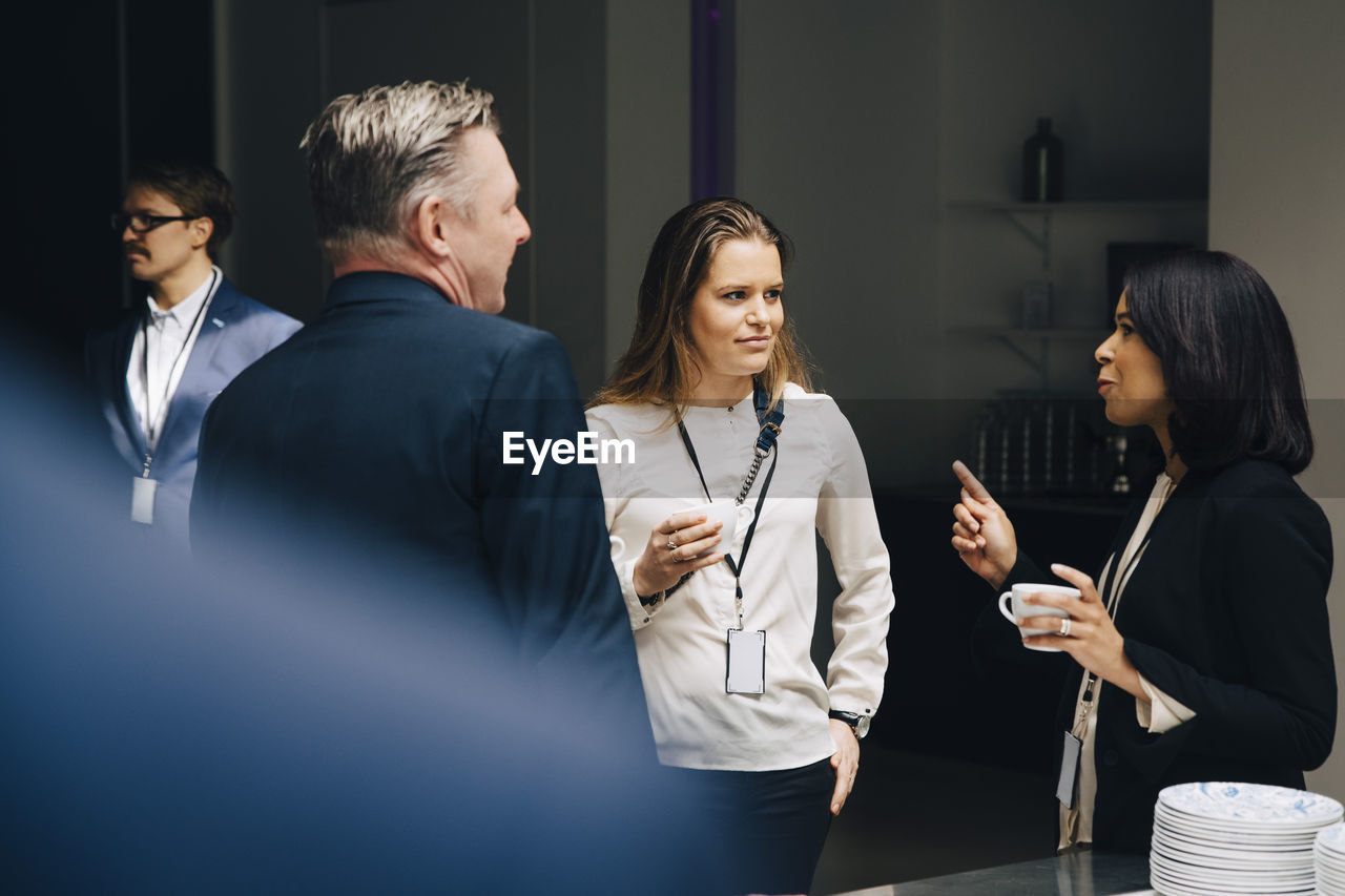 Businesswomen with businessman at office seminar