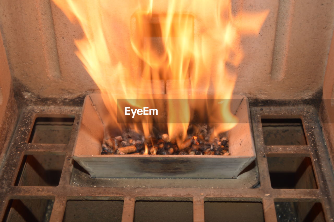 CLOSE-UP OF FIRE IN THE DARK ROOM
