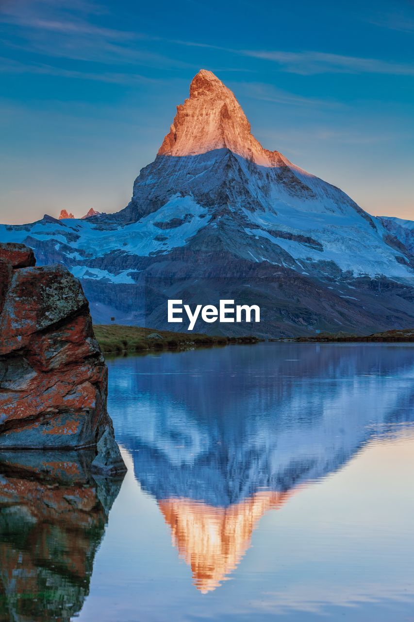 Reflection of mountain in lake against sky