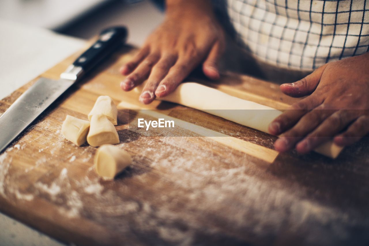 Midsection of person preparing food on table at home