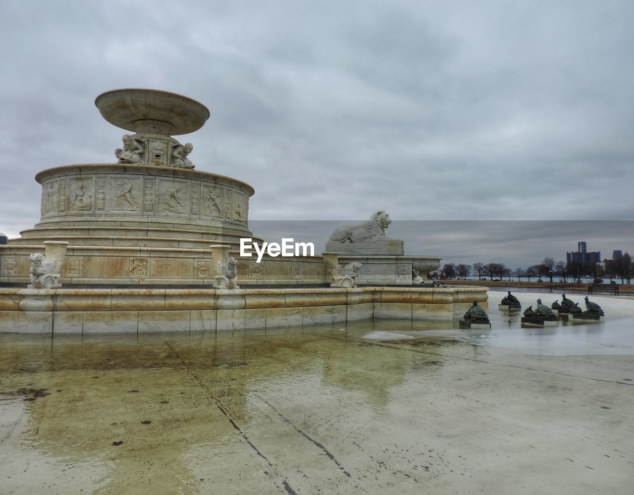 BUILT STRUCTURE IN WATER AGAINST CLOUDY SKY