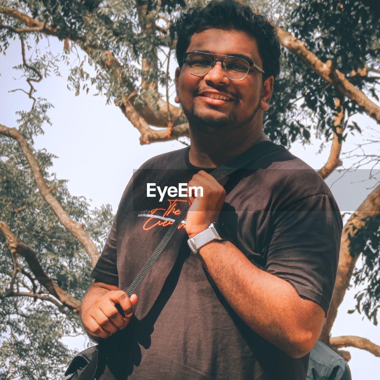 low angle view of senior man standing against trees