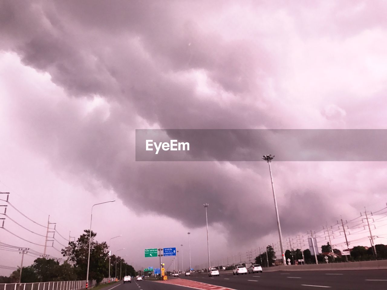 VIEW OF ROAD AGAINST CLOUDY SKY