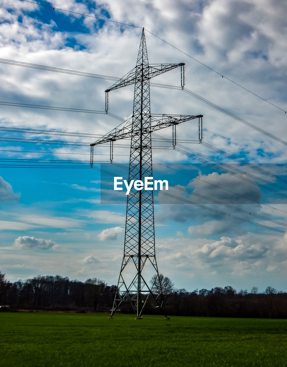sky, technology, electricity, cloud, power generation, electricity pylon, cable, power supply, transmission tower, nature, tower, overhead power line, plant, environment, power line, landscape, no people, grass, land, field, built structure, wind, outdoors, architecture, rural scene, outdoor structure, agriculture, silhouette, tree, scenics - nature, environmental conservation, day, electrical supply, industry, mast, electrical grid, metal, blue