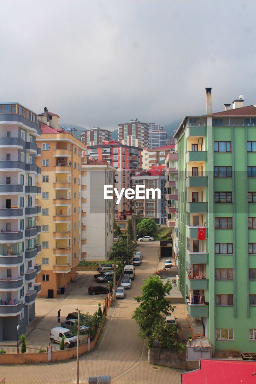 Residential buildings in city against sky