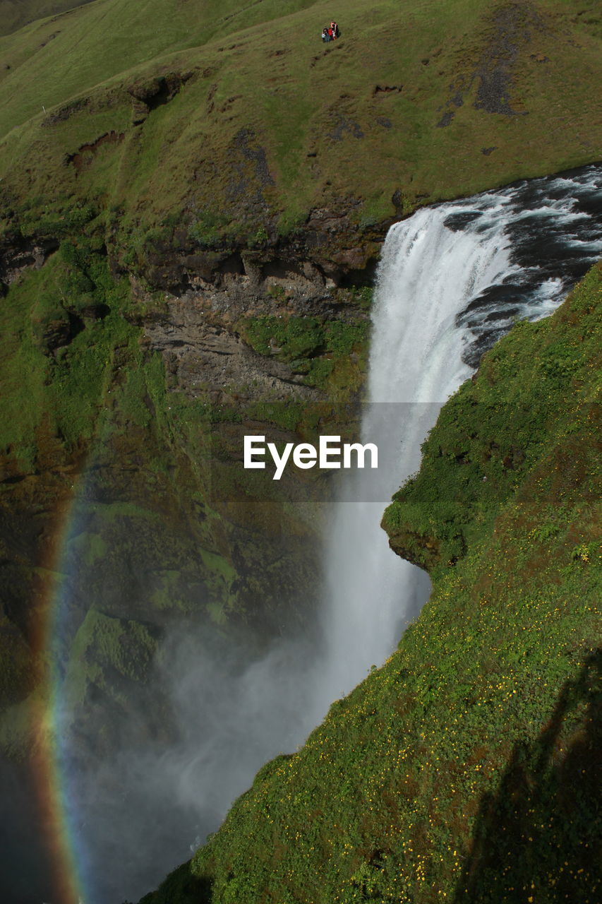 SCENIC VIEW OF WATERFALL AGAINST TREES