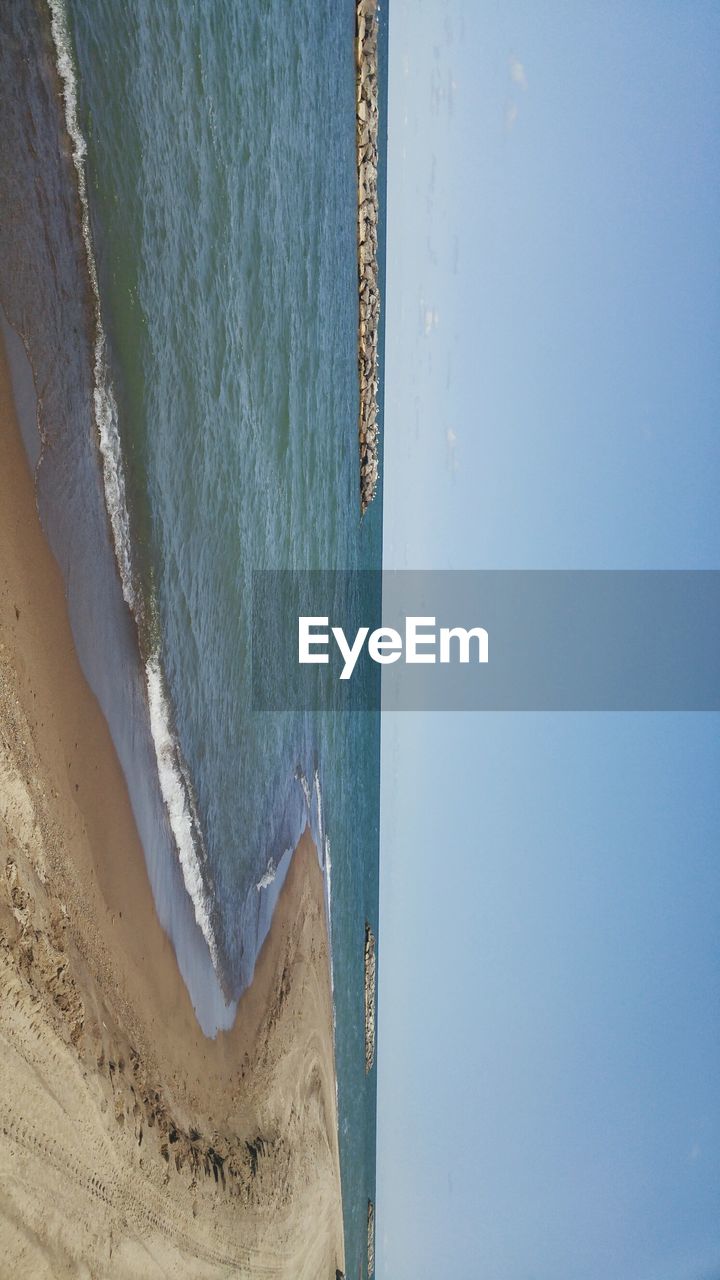 SCENIC VIEW OF BEACH AGAINST BLUE SKY