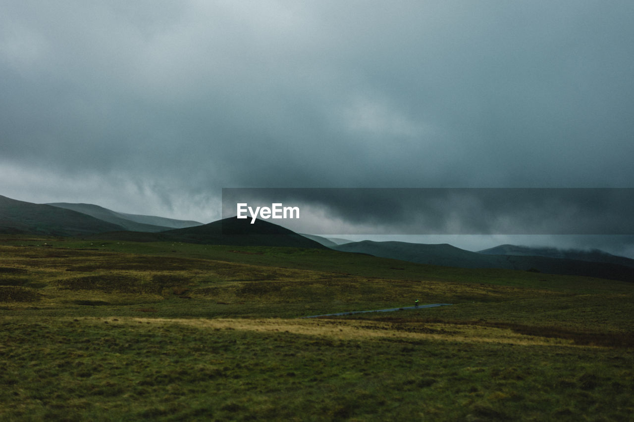 Scenic view of lake district lmisty andscape against sky with rugged moorland in the foreground 