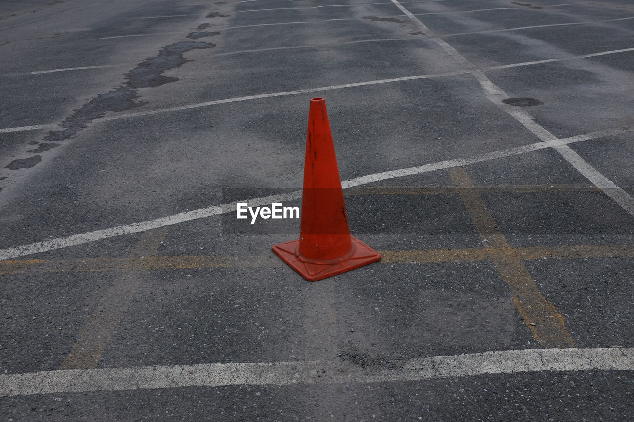 High angle view of red traffic cone at parking lot
