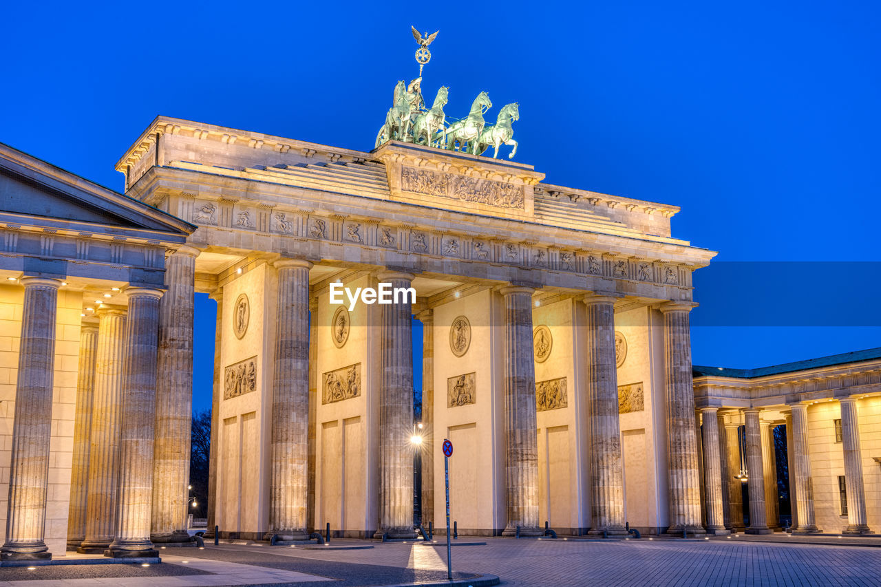 The famous illuminated brandenburg gate in berlin during blue hour