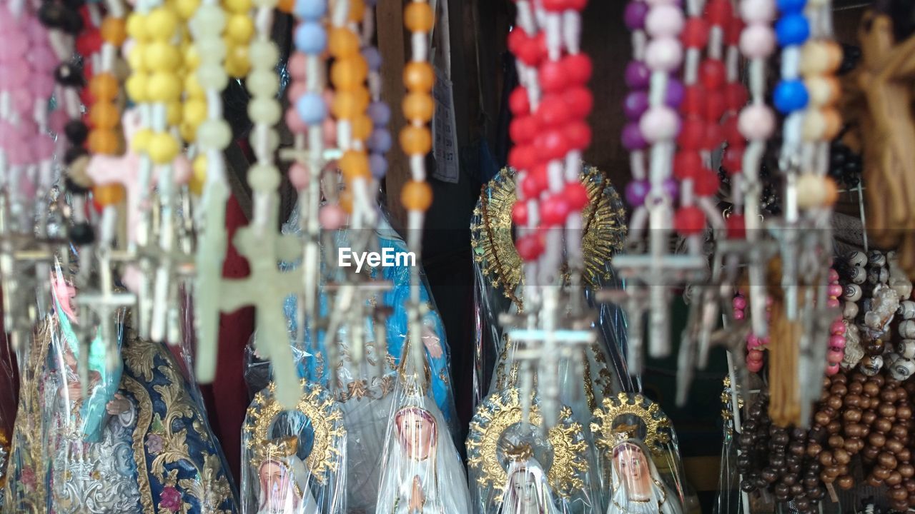 Rosary beads hanging at market for sale