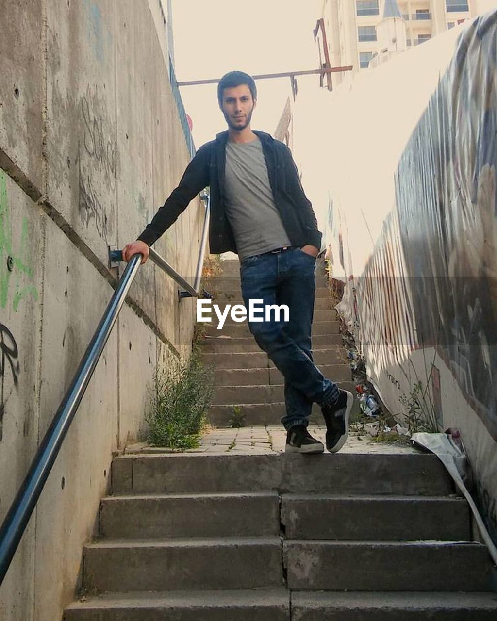 FULL LENGTH PORTRAIT OF MAN ON STAIRCASE