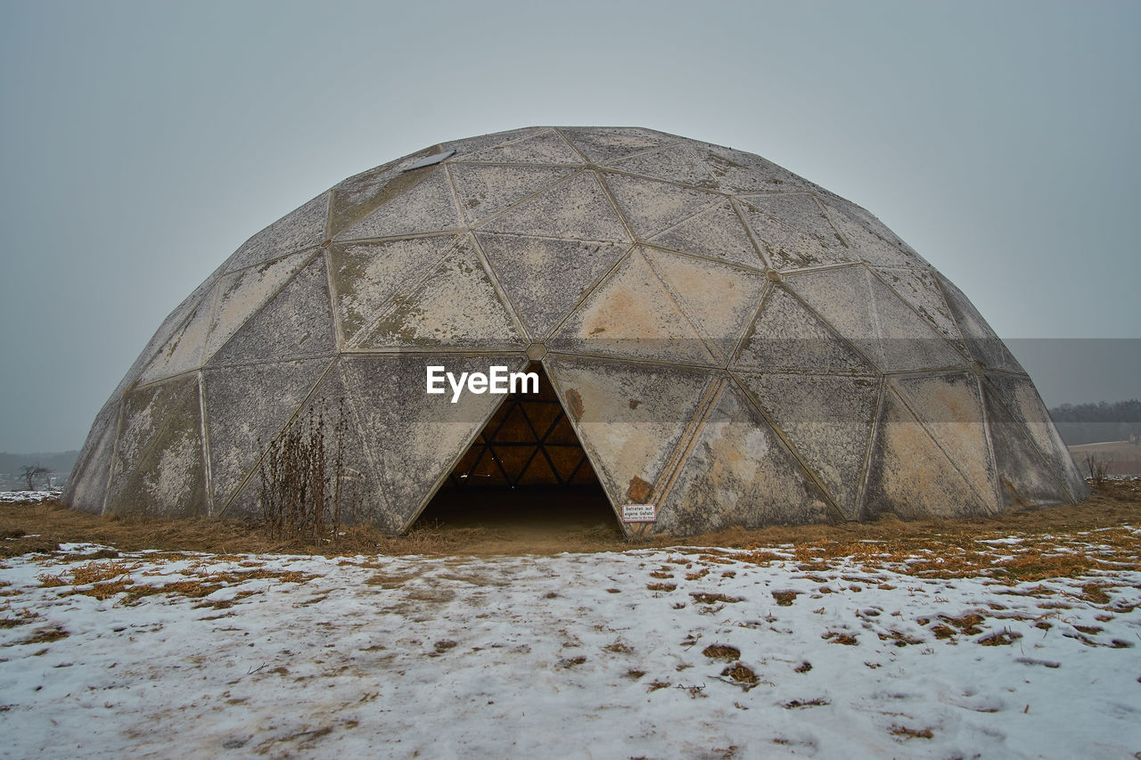 ABANDONED BUILT STRUCTURE ON SAND