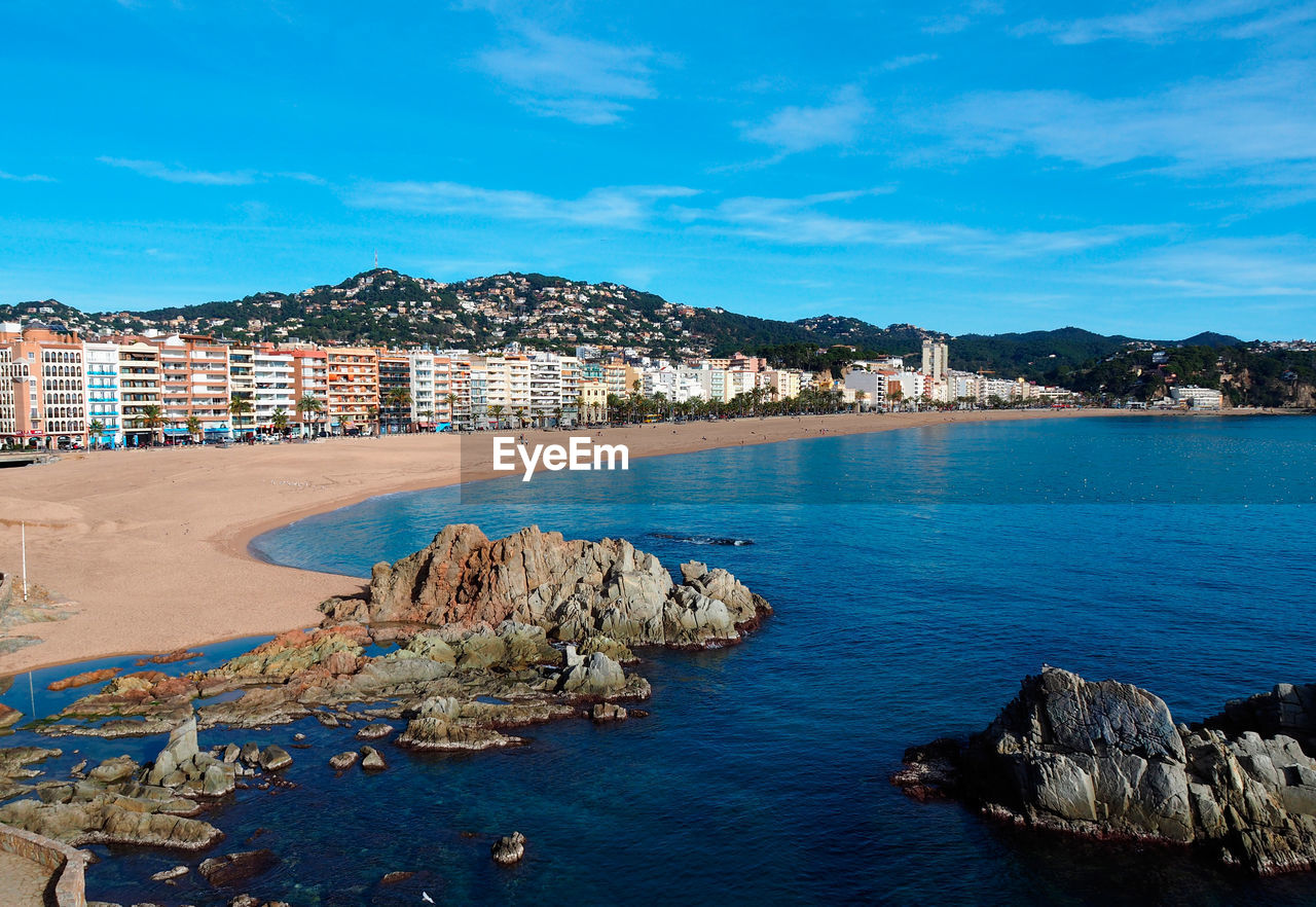 Panoramic view of sea and buildings against sky