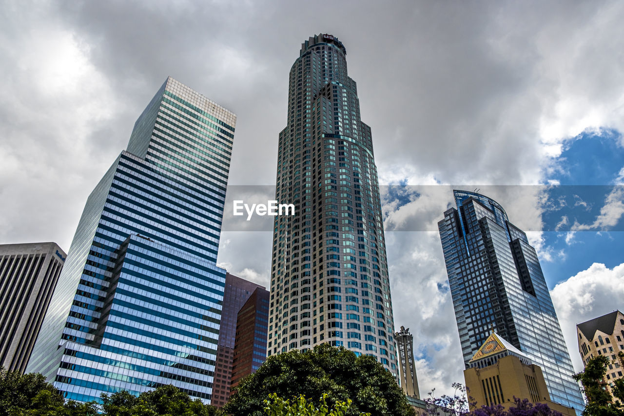 Low angle view of buildings against cloudy sky