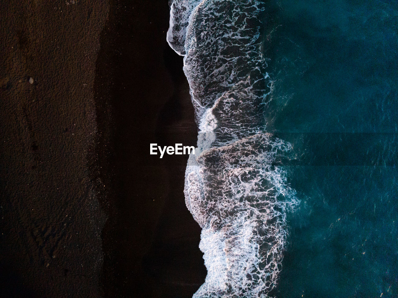 High angle view of waves splashing at shore