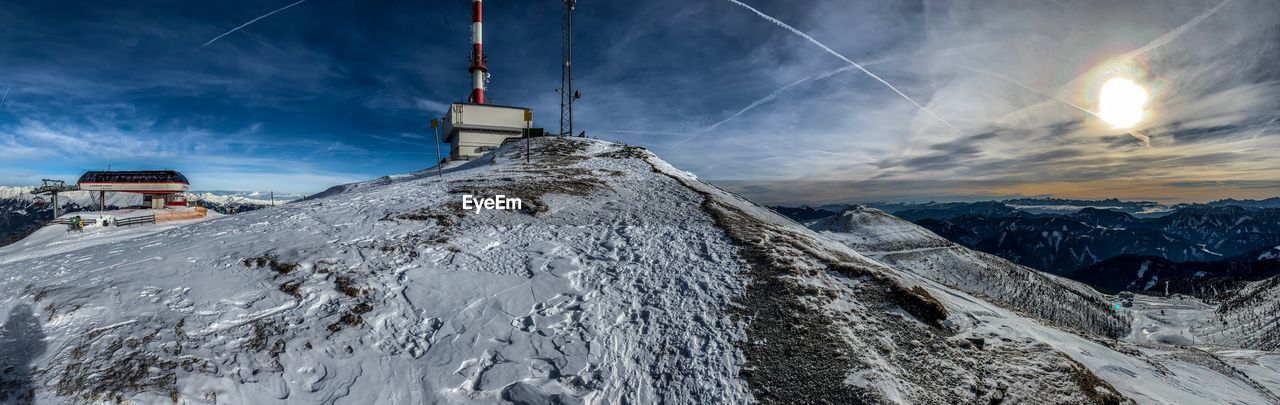 Panoramic view of snowcapped mountains against sky during winter