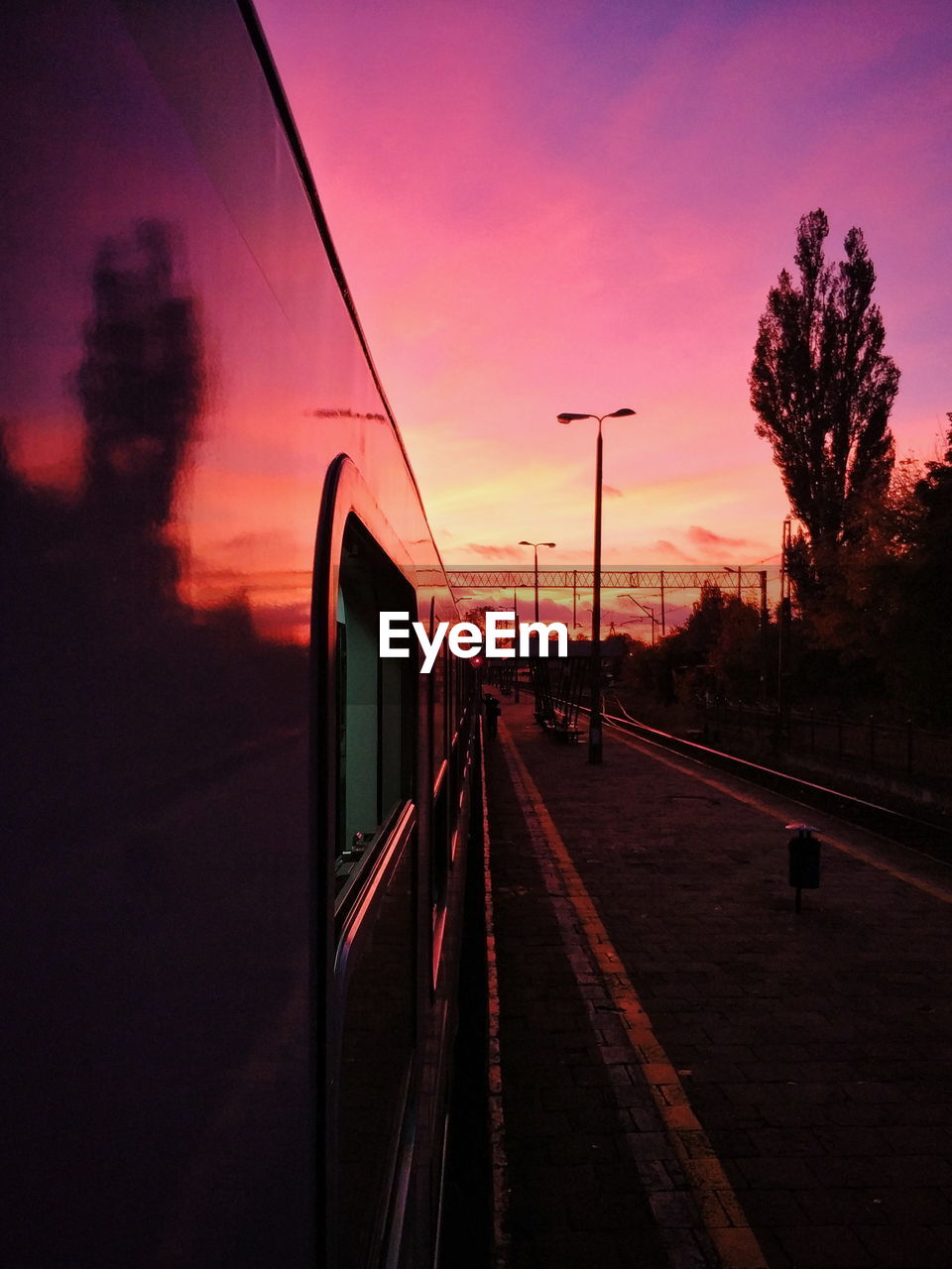 RAILROAD TRACKS AGAINST SKY DURING SUNSET