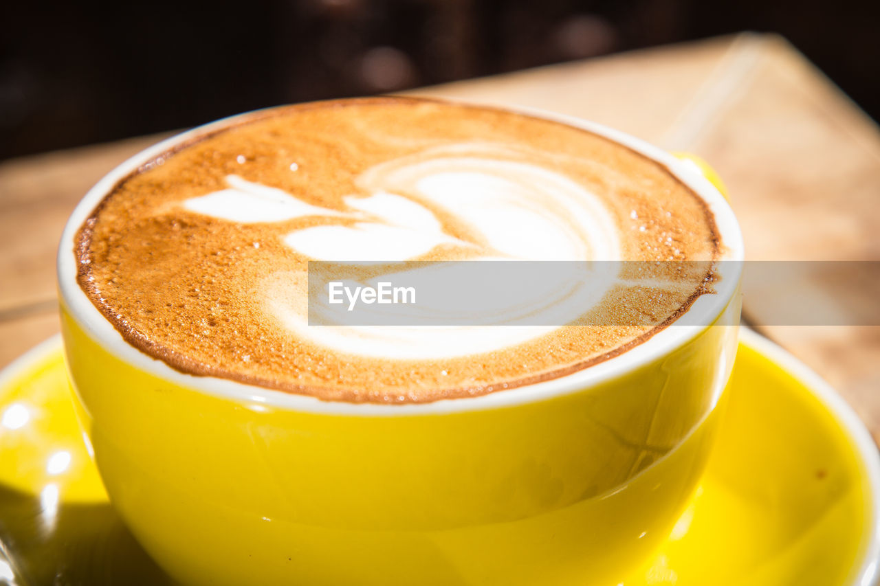 High angle view of cappuccino on wooden table