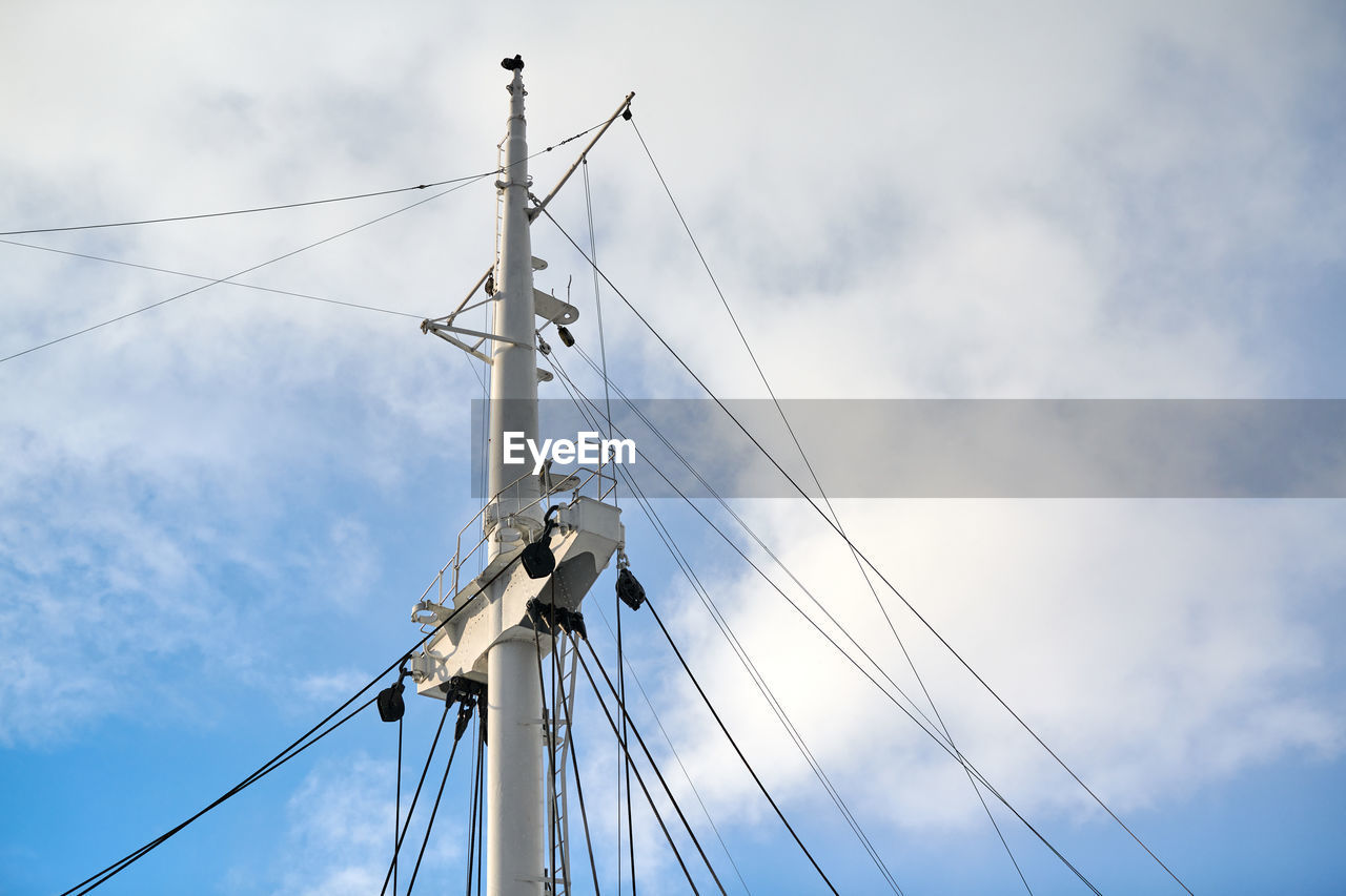 Sailing mast of ship on blue cloudy sky background, copy space. sailing vessel main topgallant mast