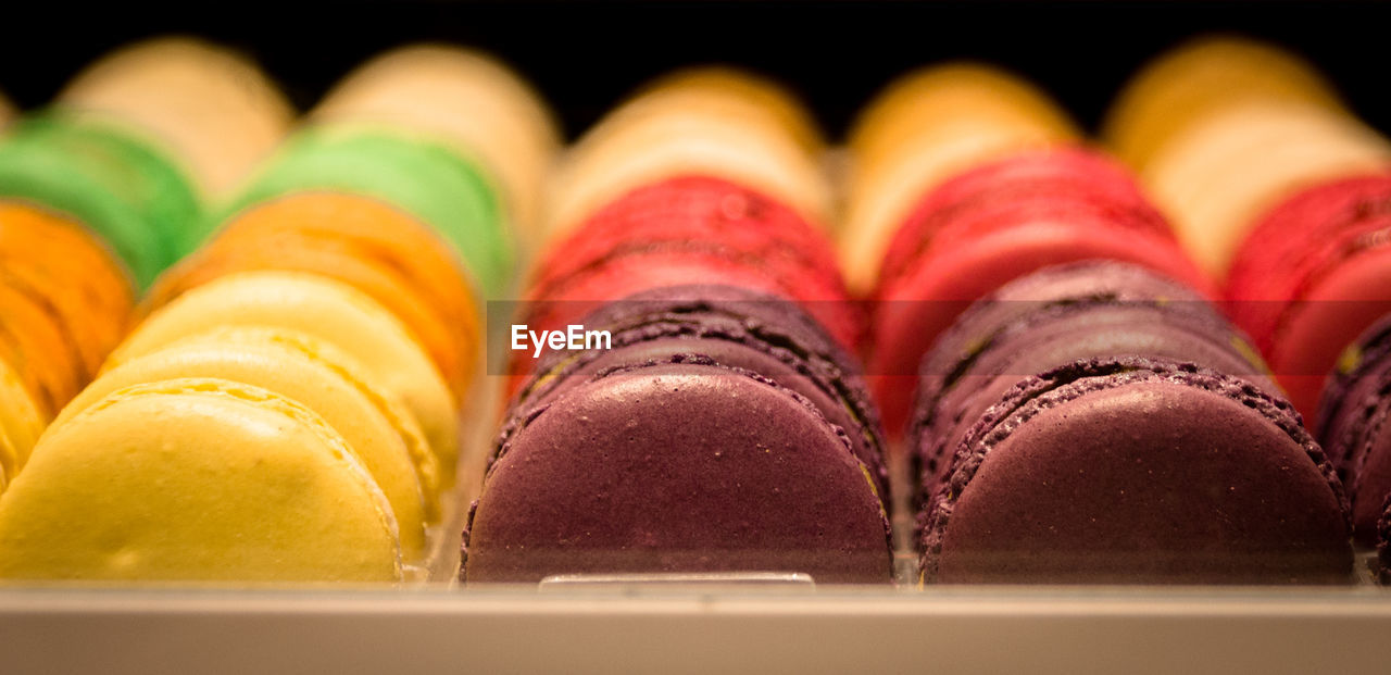 Close-up of colorful macaroons in tray