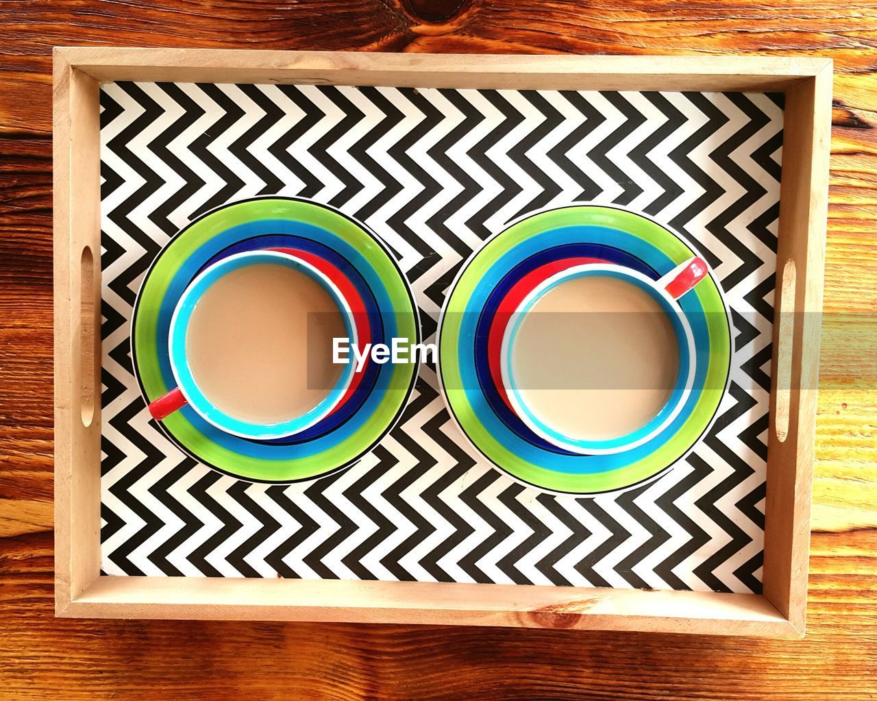 Directly above shot of coffee cups in zigzag tray