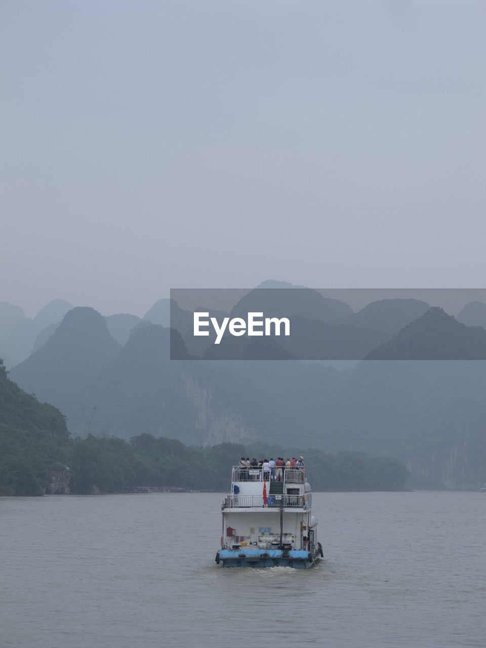 Boat in sea against mountains in li river, guilin, china,
