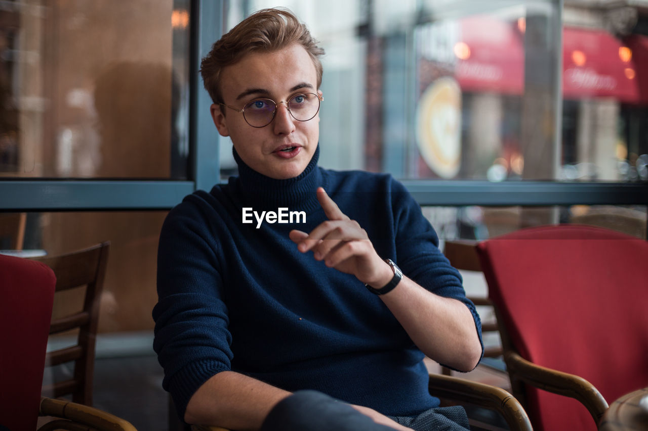 Portrait of young man sitting in cafe