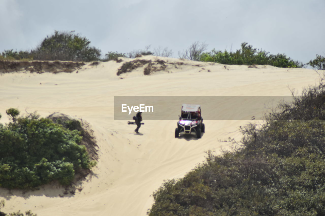 VIEW OF TIRE TRACKS IN SAND