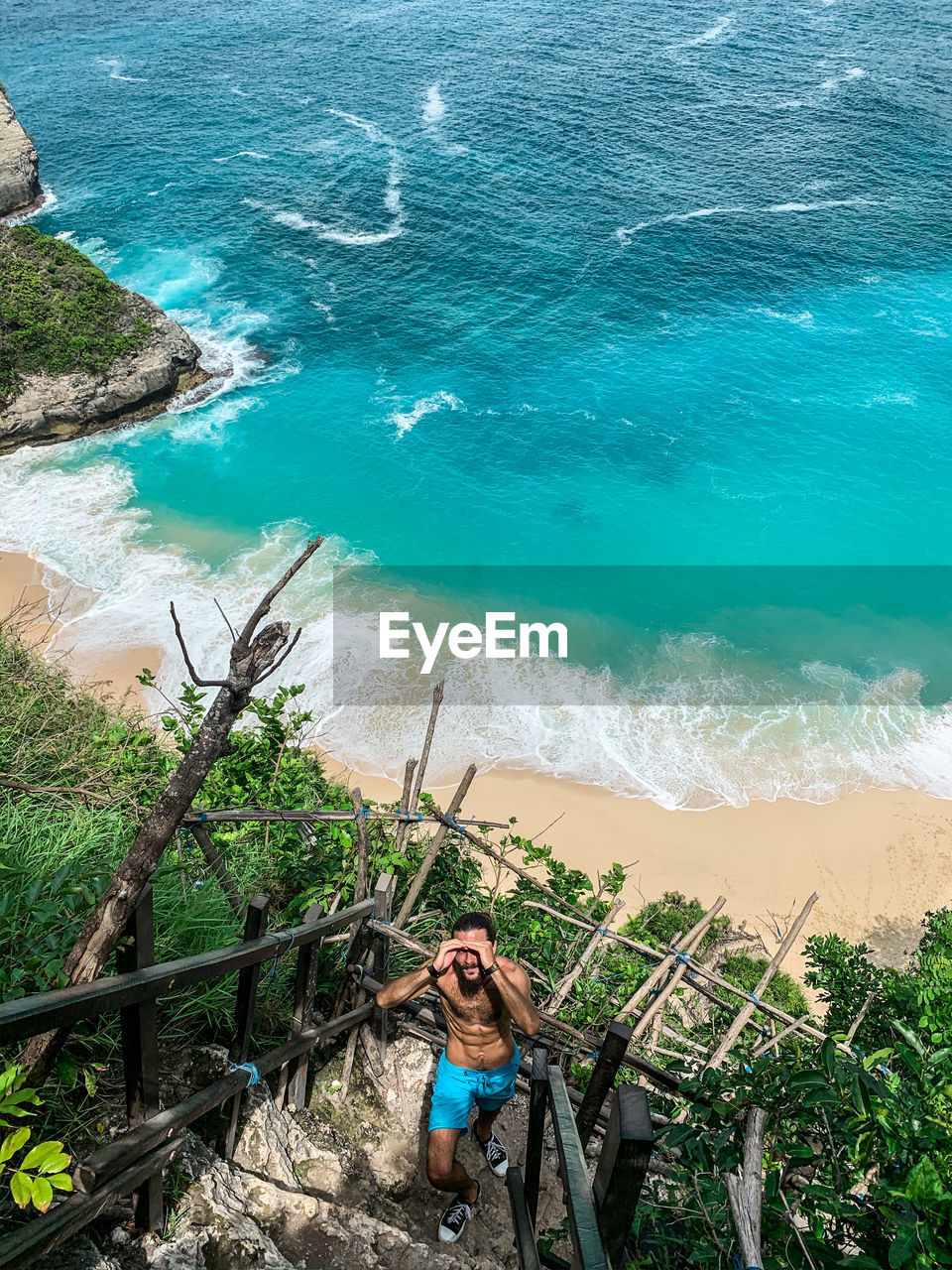 HIGH ANGLE VIEW OF YOUNG MAN ON BEACH