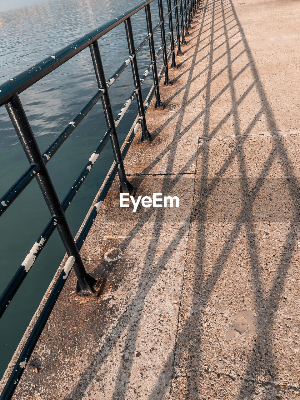 HIGH ANGLE VIEW OF METAL FENCE ON RAILING