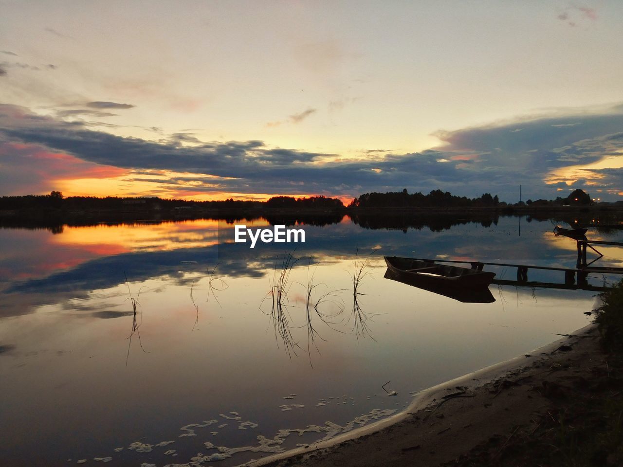 Scenic view of lake against sky during sunset