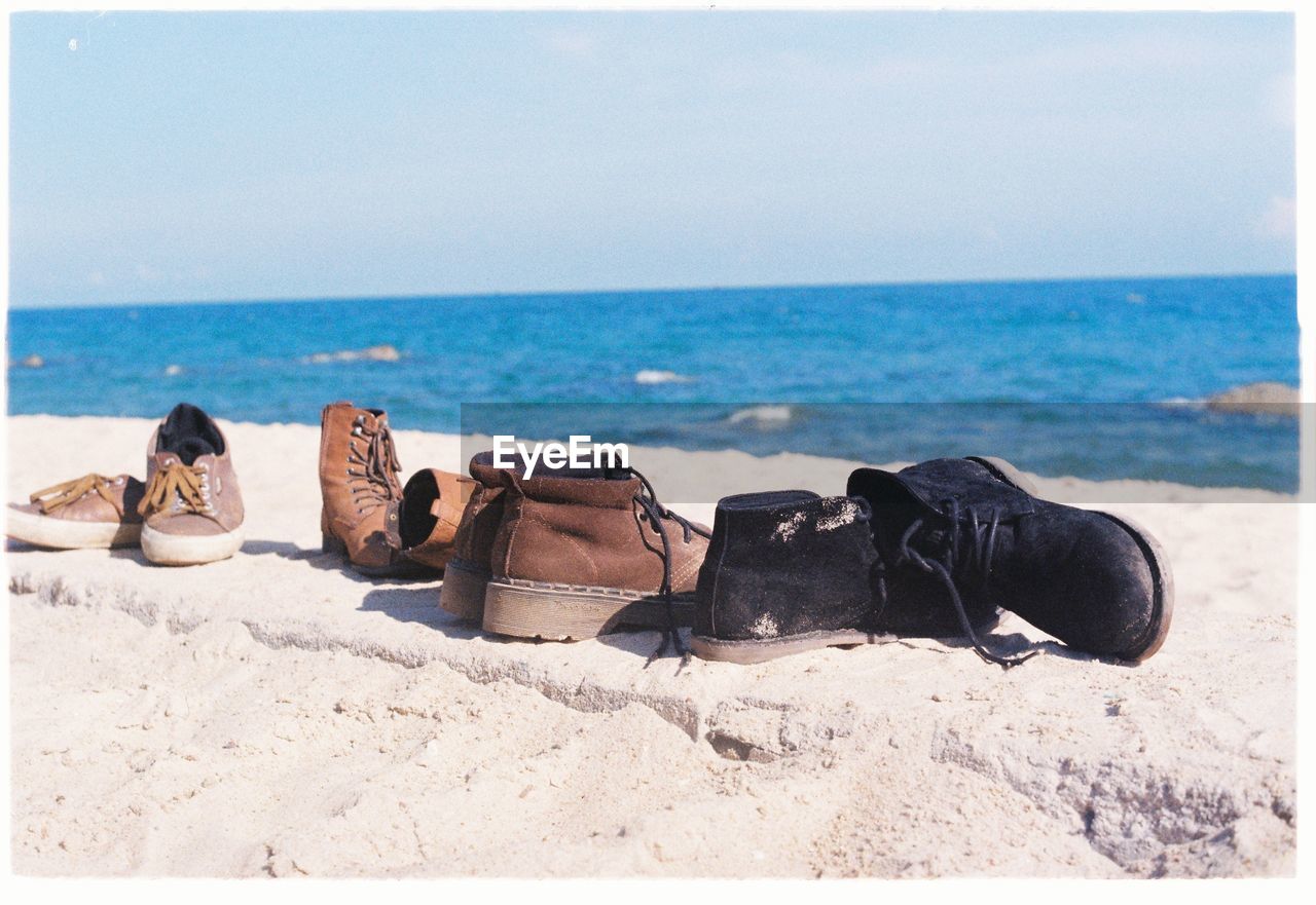 Shoes and boots on shore on sunny day