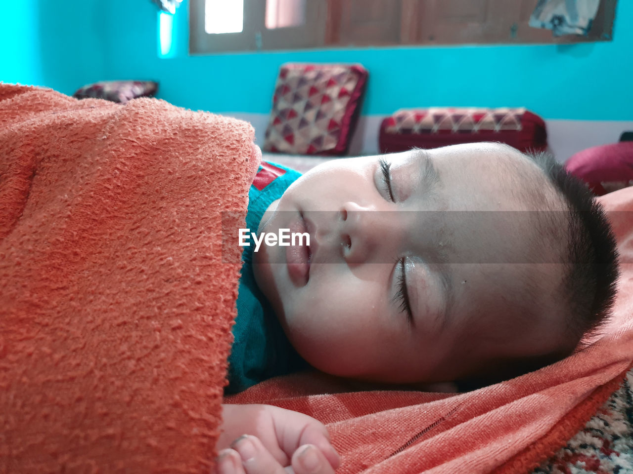 PORTRAIT OF BABY SLEEPING IN BED