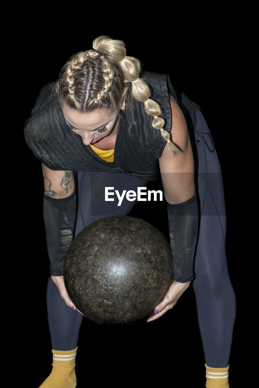 Woman from the basque country practicing stone lifting rural sport