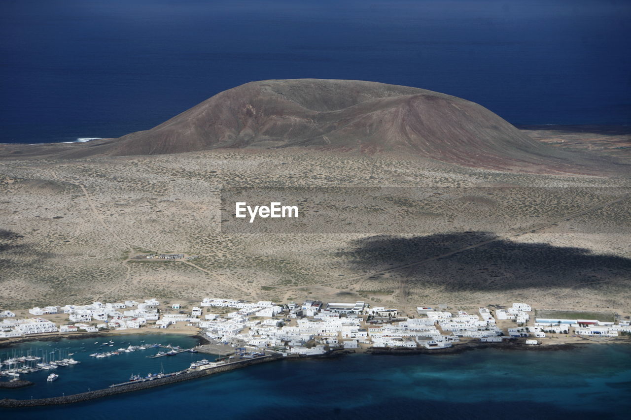 Scenic view of volcanic mountain and sea