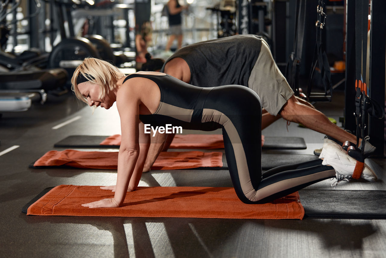 Side view of woman exercising at gym