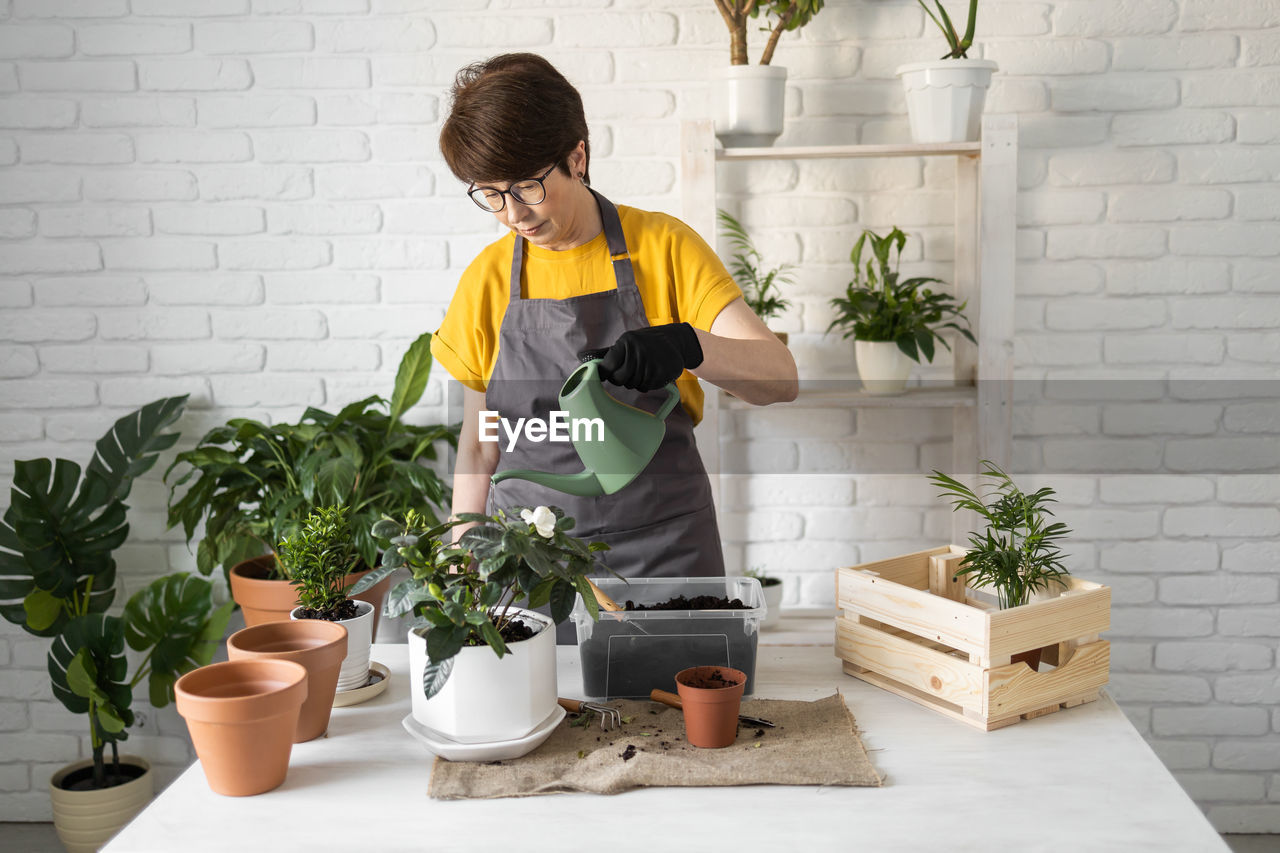 side view of woman gardening in kitchen