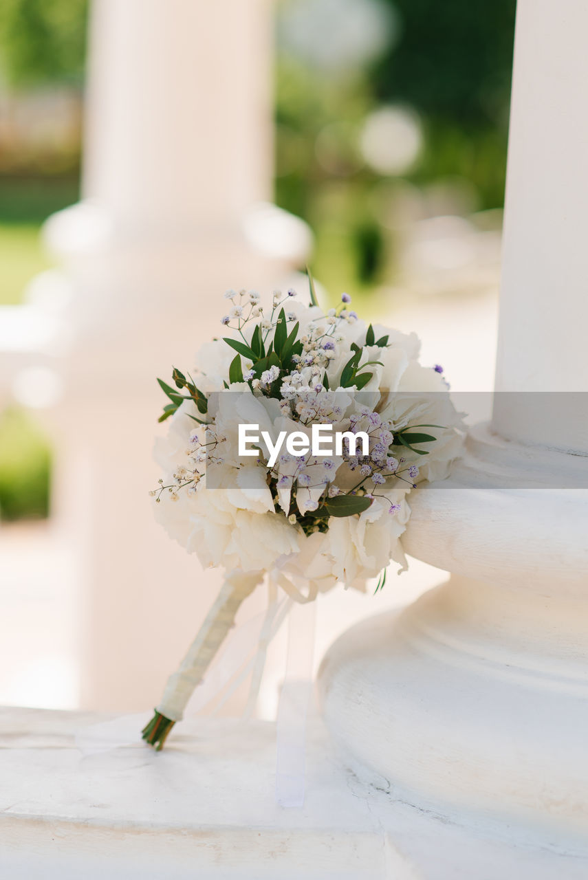 Beautiful bouquet of the bride in white with greenery