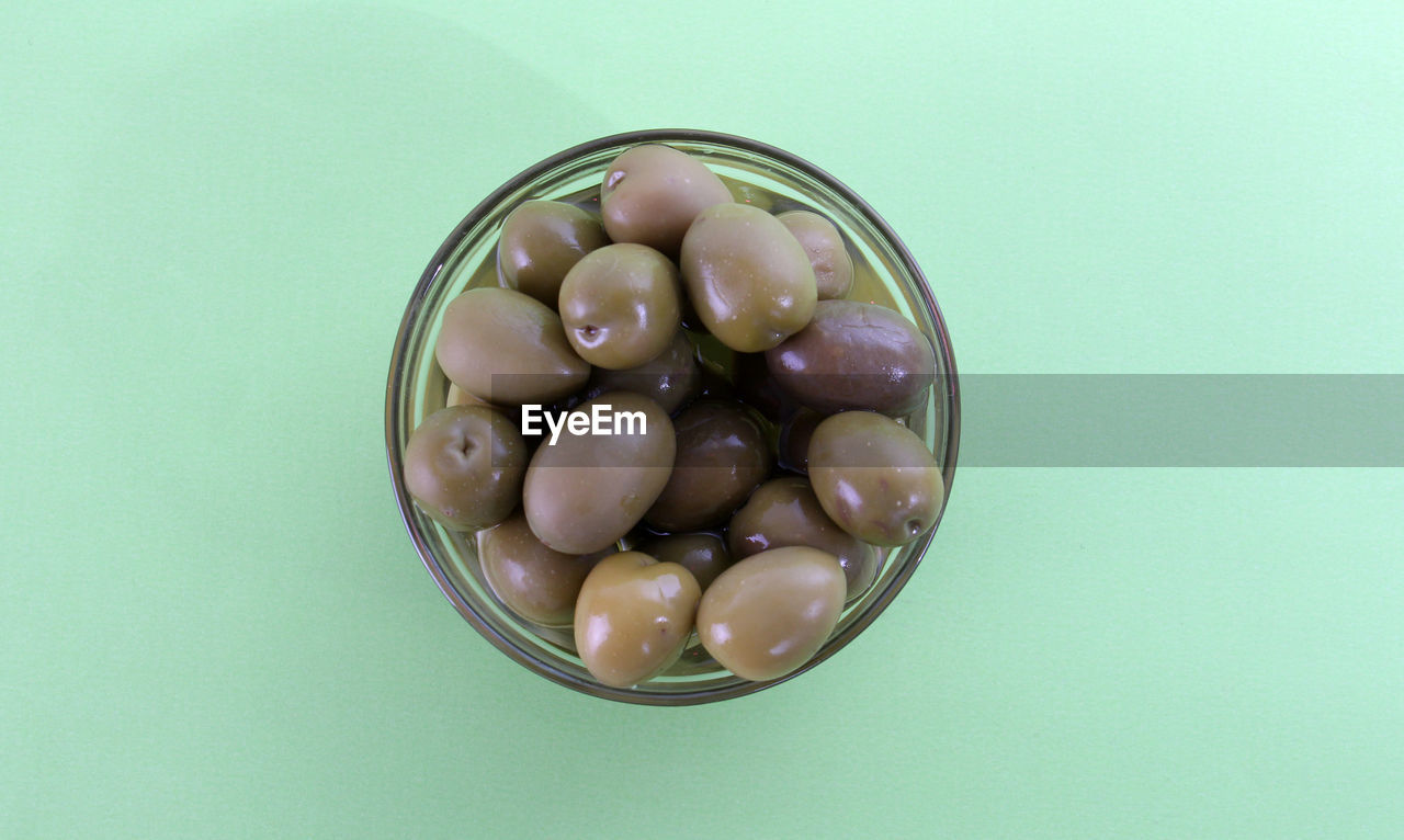 Close-up of olives in bowl over table