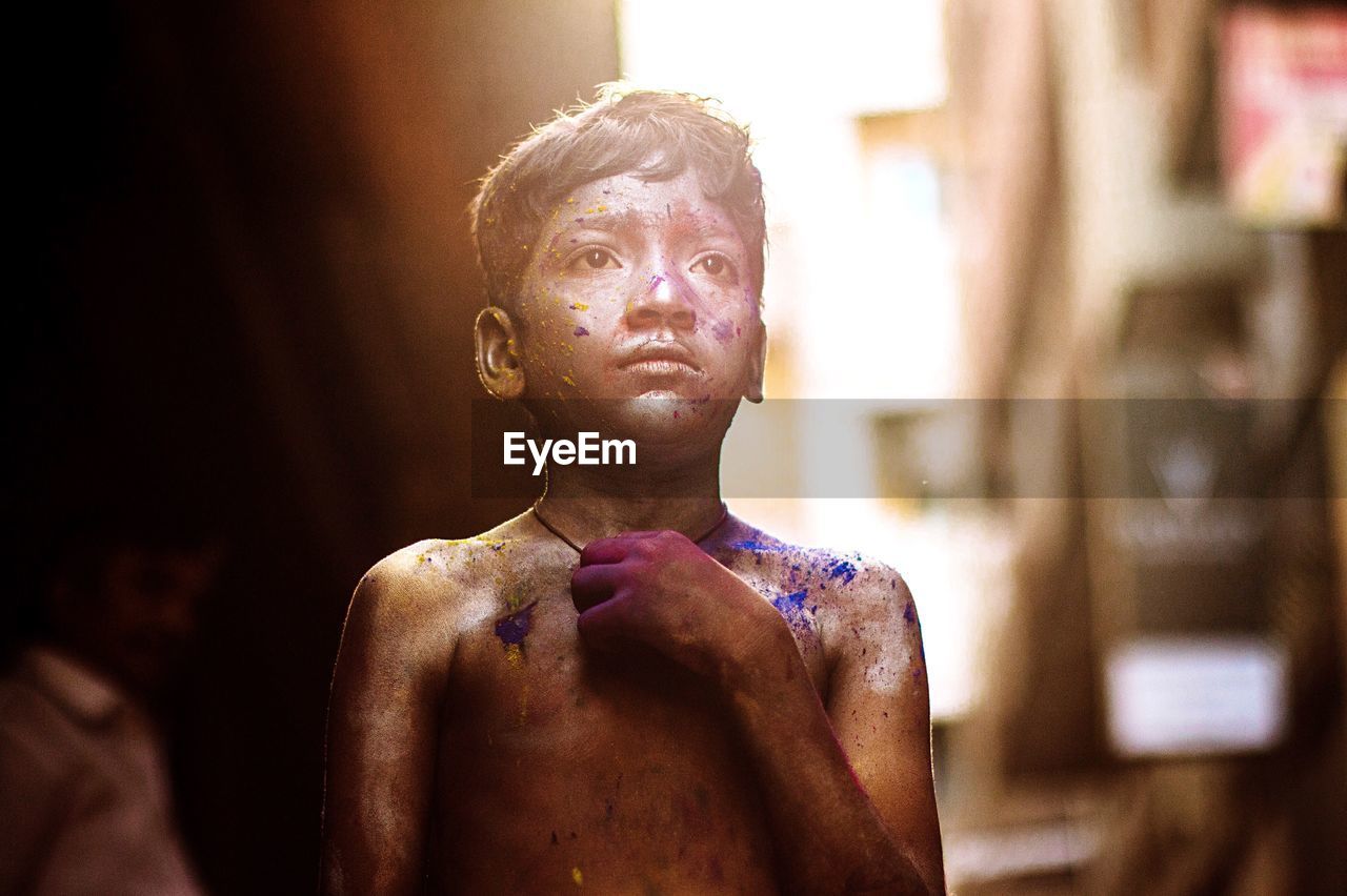 Boy standing outdoors during holi