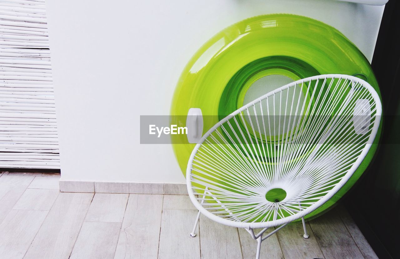 CLOSE-UP VIEW OF ELECTRIC FAN IN GREEN BACKGROUND