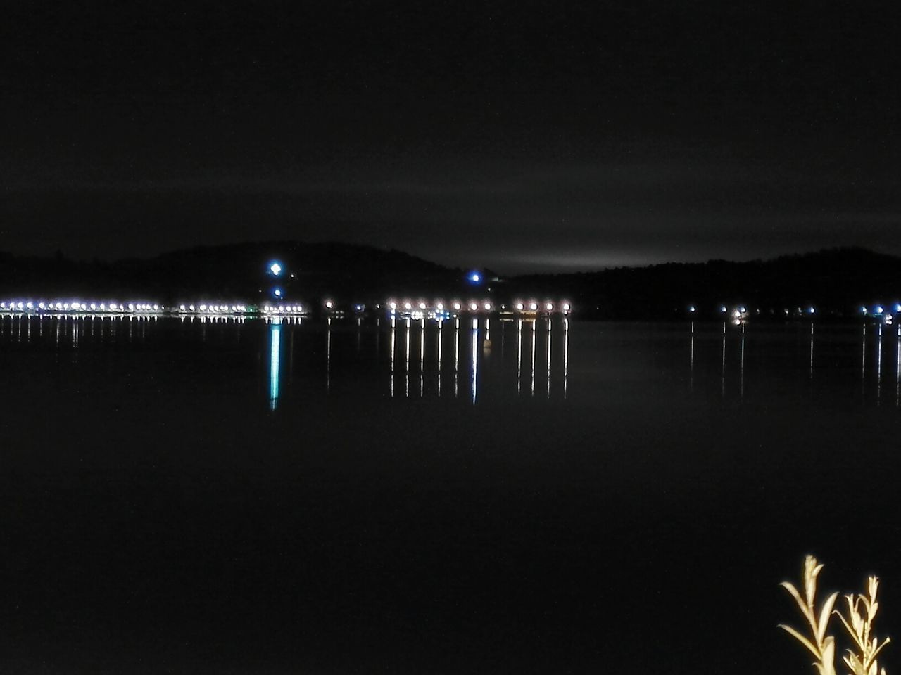 VIEW OF ILLUMINATED SEA AT NIGHT