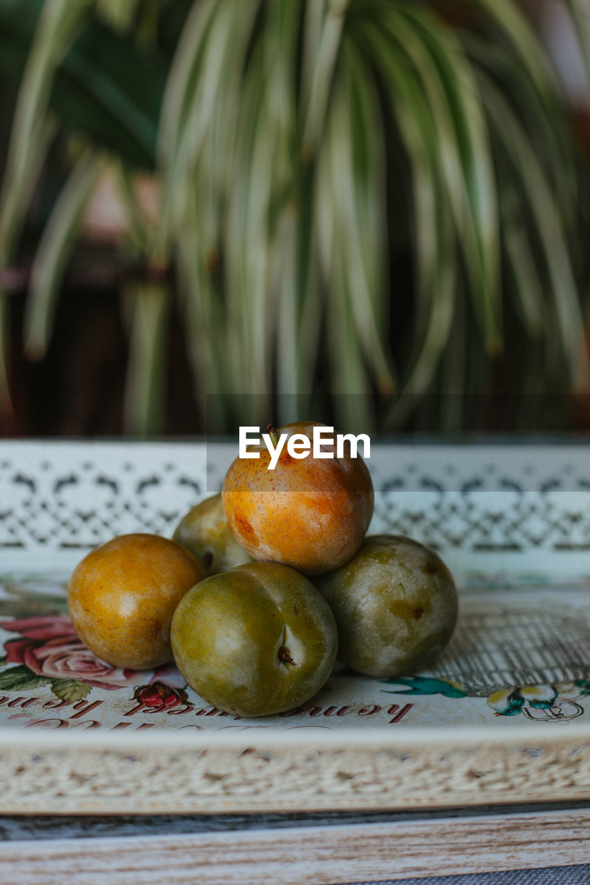 Close-up of plums in plate on table